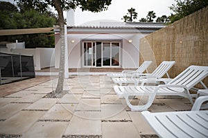 Row of sunbeds onpatio of a private home