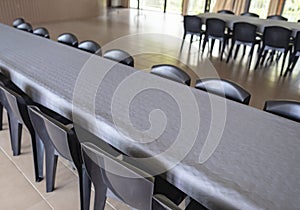 Row Of Tables And Chairs With Grey Paper Tablecloths