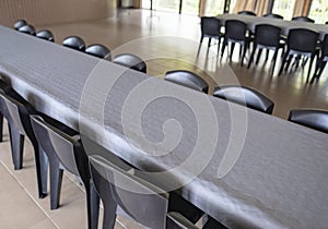 Row Of Tables And Chairs With Grey Paper Tablecloths photo