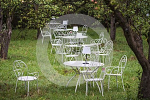 Row of tables and chairs at an open-air restaurant