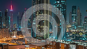 Row of the tall buildings around Sheikh Zayed Road and DIFC district aerial night timelapse in Dubai