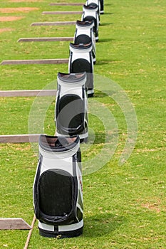 Row of Taylormade Golf Bags outdoor in rainy weather at Saadiyat Golf course Abu Dhabi