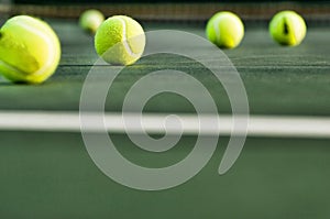 Row of Tennis Balls on Court Surface