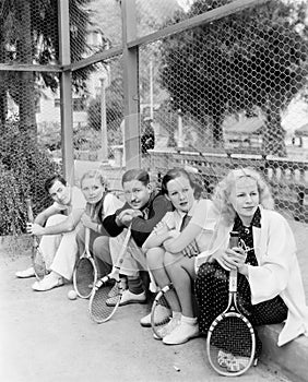 Row of tennis players with rackets