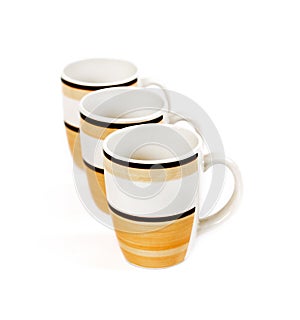 Row of three mugs isolated on white