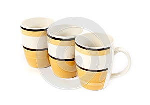 Row of three mugs isolated on white