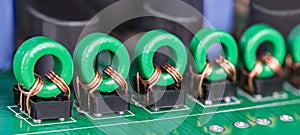 Row of toroidal transformer inductors on PCB for audio or video signal galvanic isolation