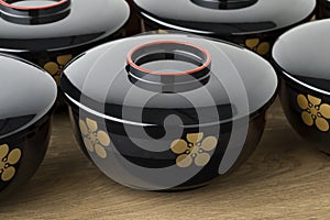 Row of traditional black lacquered Japanese bowls