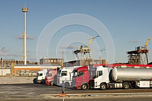 Row of trucks in front of refinery