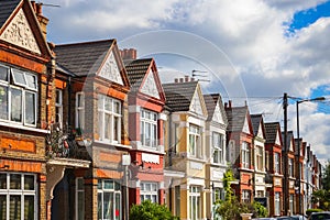 A row of typical red brick British terraced houses in London
