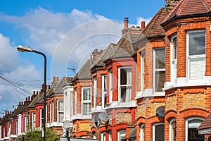 A row of typical red brick British terraced houses in London photo