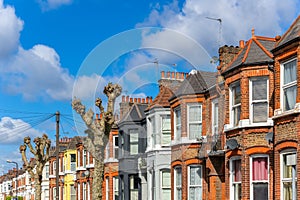 A row of typical red brick British terraced houses in London photo