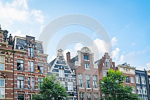 Row of typically Dutch canal houses with their variety and diversity of  facade and gable styles