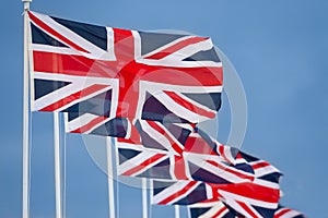 Row of Union Jack British Flags on Flagpoles