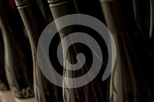 Row of Unopened Dark Bottles of Wine or Liquor