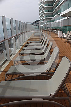 Row of unused sun loungers on the cruise ship Iona