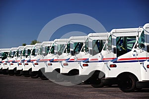 US postal service trucks parked in a line.