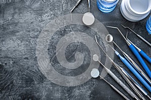 Row of various dental tools isolated on gray background.