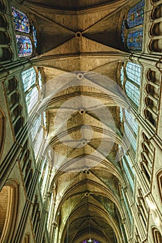 Row of vaulted, arched ceilings with two rows of stained glass windows photo