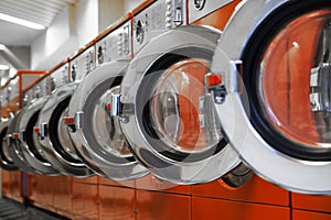 Row of washing machines in laundromat photo
