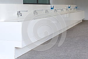 Row of Water Tap and Sink in School