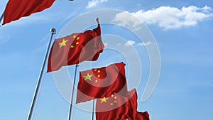 Row of waving flags of China agaist blue sky, 3D rendering