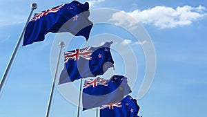 Row of waving flags of New Zealand agaist blue sky, 3D rendering