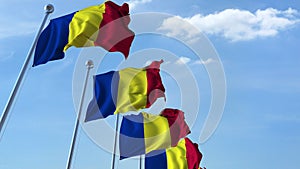 Row of waving flags of Romania agaist blue sky, 3D rendering