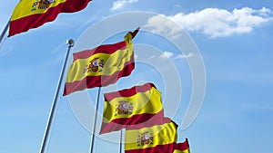 Row of waving flags of Spain agaist blue sky, 3D rendering