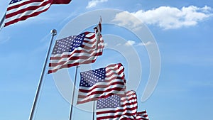 Row of waving flags of the United States agaist blue sky, 3D rendering