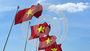 Row of waving flags of Vietnam agaist blue sky, 3D rendering