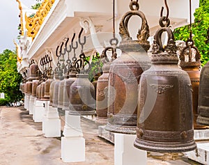 Row of Weathered Bronze Bells in Buddhism Temple, Thailand