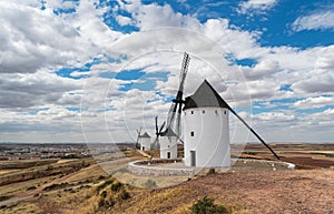 Row of white ad black windmills in Castilla La Manha village Spain photo