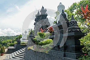 Row of white cement buddha statue with sunlight. A row of white Buddha statues at the Brahma Vihara Arama Temple in Bali