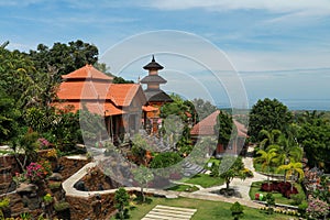 Row of white cement buddha statue with sunlight. A row of white Buddha statues at the Brahma Vihara Arama Temple in Bali