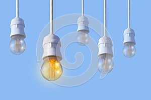 A row of white electric light bulbs on a blue background.