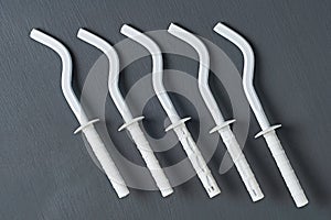 Row of white new modern hooks for mount aluminum or bimetallic radiators for heating house