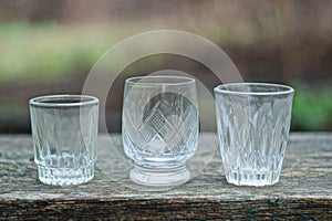 A row of white one three glass crystal goblets