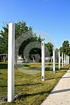 Row of white vinyl posts for backyard fence