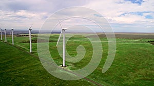 Row of wind turbines with their props rotating in the wind
