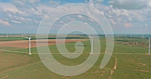 This is row of windmill renewable energy turbines on a wind farm in the country of Texas, USA