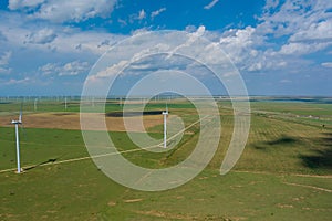 This is row of windmill renewable energy turbines on a wind farm in the country of Texas, USA