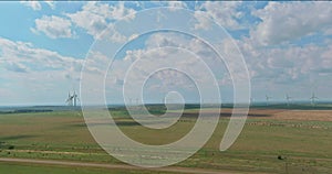 Row of windmill renewable energy turbines on a wind farm in the Texas