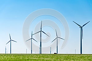 A row of windmills in the American plains