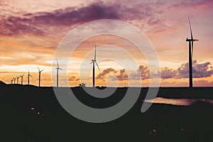 A row of windmills during golden hour in Bangui, Ilocos Norte, Philippines. Sustainable and renewable energy in Asia