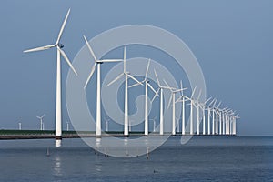 Row of windmills, mirrored in the Dutch sea