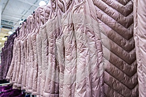 Row of womens down wests.