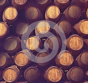 Row of wooden barrels of tawny portwine ( port wine ) in cellar, Porto, Portugal