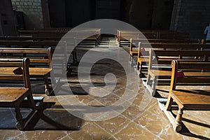 Row of wooden benches inside a church