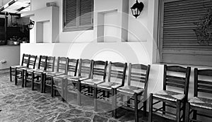 Row of wooden chairs on house front
